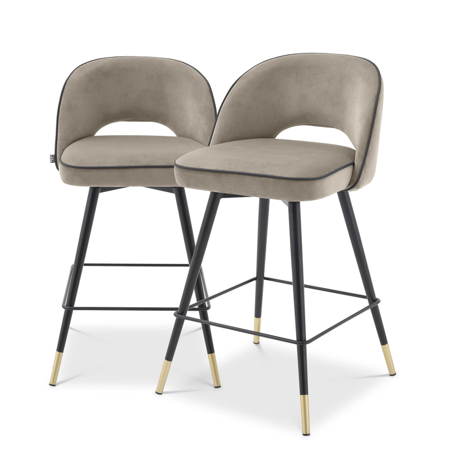 Set of two Eichholtz Cliff hocker stools in Savona greige velvet